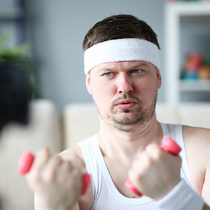 Harry Smith wearing a headband and lifting comically small pink weights!